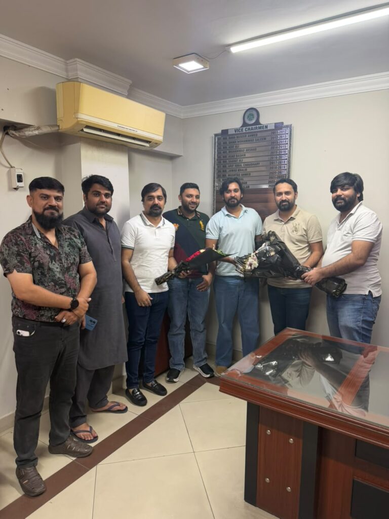 Members presenting bouquets during a congratulatory visit for PSGMEA Vice Chairman Ahmed Imtiaz Khan.